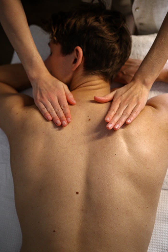 hero-img-02 Man receiving relaxing massage therapy on upper back at spa.